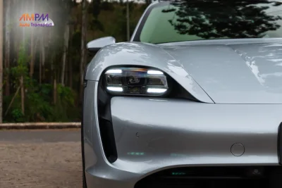 Porsche Taycan electric car driving on a scenic road