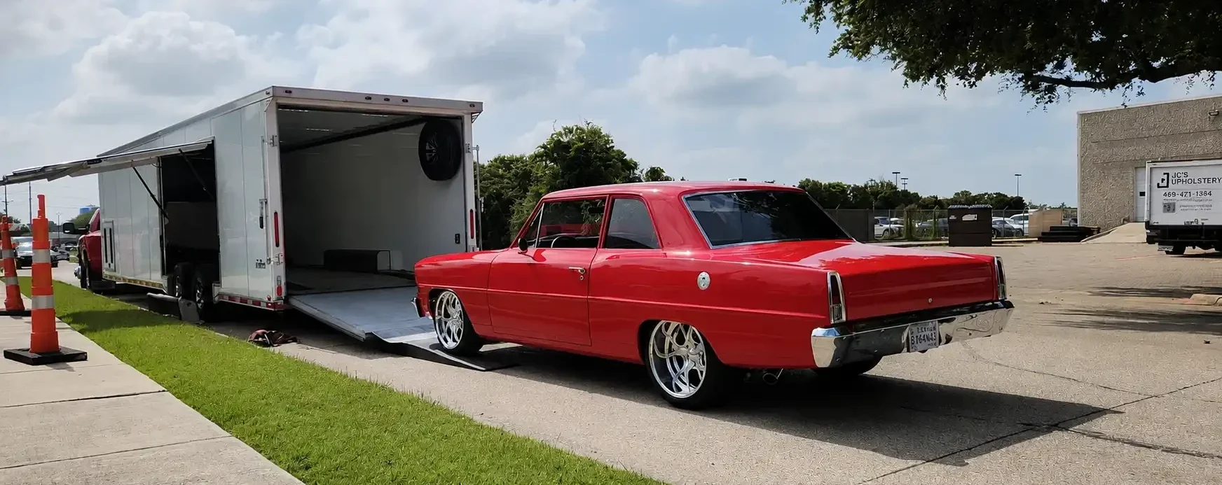 red-luxury-car-loading-into-enclosed-trailer