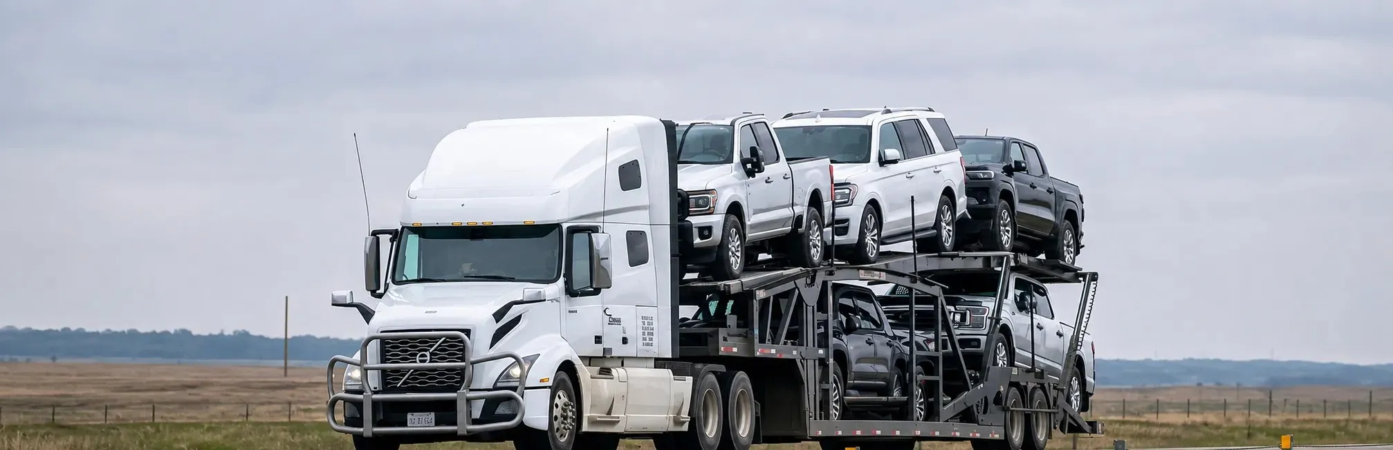 White truck loaded with cars